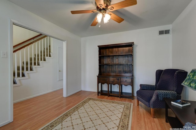 5810 Windvale, Windcrest, TX 78239 - sitting room featuring wood finished floors, stairs, a ceiling fan, and baseboards
