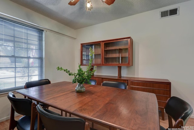 5810 Windvale, Windcrest, TX 78239 - dining space featuring ceiling fan, light wood-type flooring, a textured ceiling, and baseboards
