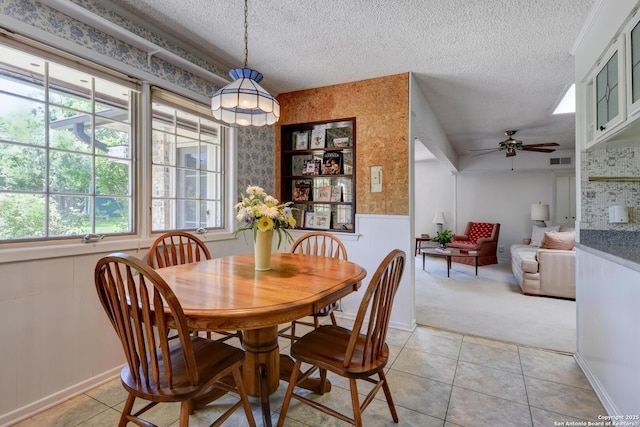 5810 Windvale, Windcrest, TX 78239 - dining room with a textured ceiling, light tile patterned flooring, plenty of natural light, a ceiling fan, and wainscoting