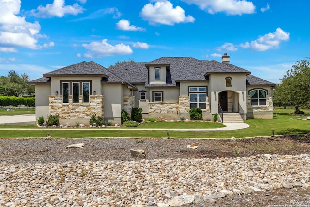 2319 Cascada, Spring Branch, TX 78070 - view of front of home with stucco siding, a chimney, stone siding, and a front yard