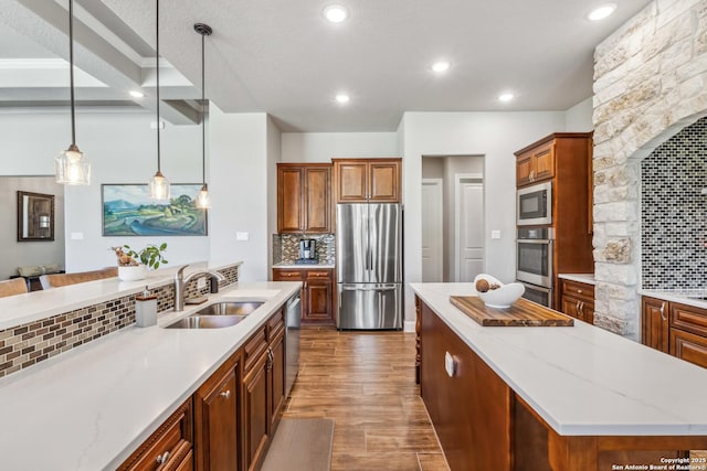 2319 Cascada, Spring Branch, TX 78070 - kitchen with appliances with stainless steel finishes, a sink, a center island, tasteful backsplash, and dark wood finished floors