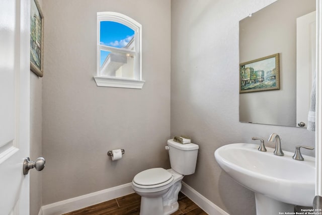 2319 Cascada, Spring Branch, TX 78070 - half bath featuring wood finished floors, baseboards, toilet, and a sink