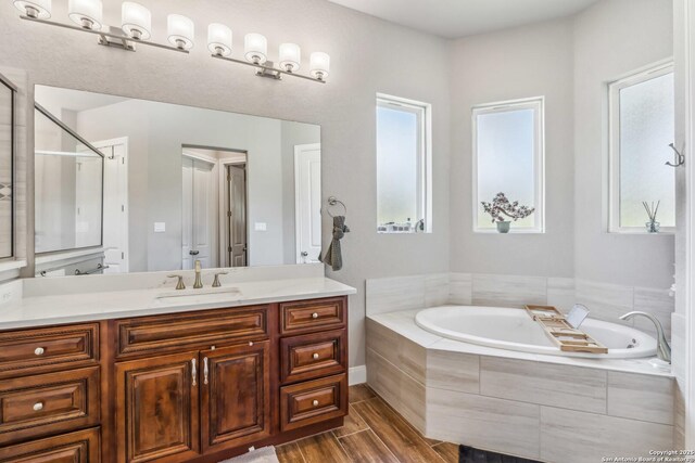 2319 Cascada, Spring Branch, TX 78070 - full bath featuring a bath, vanity, an enclosed shower, and wood finished floors