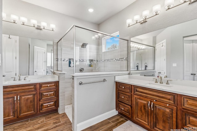 2319 Cascada, Spring Branch, TX 78070 - full bathroom with a tile shower, two vanities, and wood finish floors