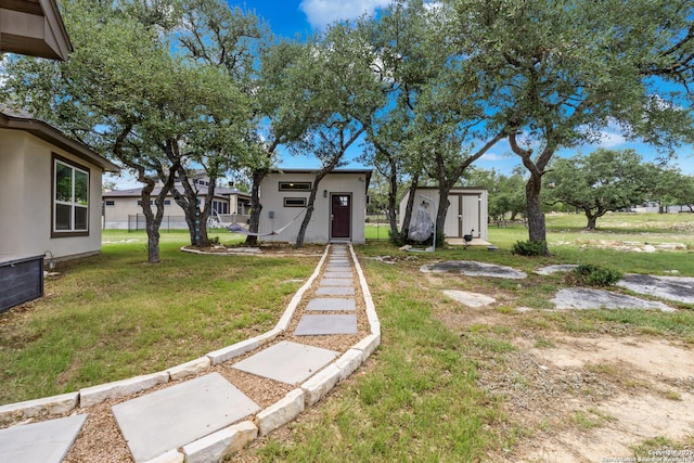 2319 Cascada, Spring Branch, TX 78070 - view of green lawn featuring a storage unit and an outbuilding