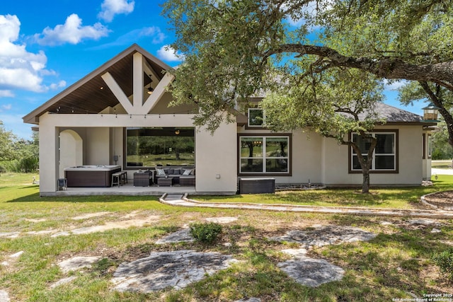 2319 Cascada, Spring Branch, TX 78070 - rear view of property featuring a patio area, a hot tub, stucco siding, outdoor lounge area, and a yard