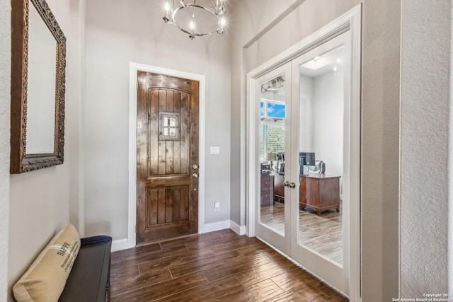 2319 Cascada, Spring Branch, TX 78070 - foyer entrance with french doors, dark wood-style flooring, a chandelier, and baseboards