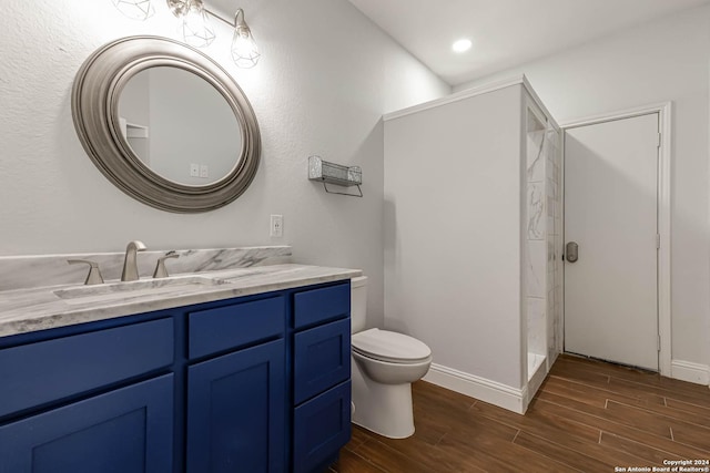 19146 Mcconnell Rd, Atascosa, TX 78002 - full bath featuring wood finished floors, toilet, vanity, and walk in shower