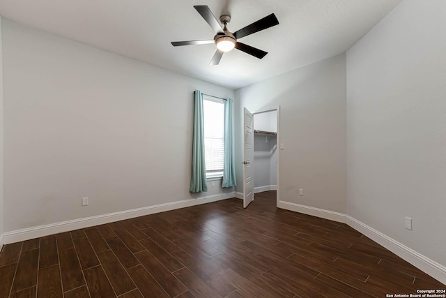 19146 Mcconnell Rd, Atascosa, TX 78002 - empty room featuring a ceiling fan, dark wood-style flooring, and baseboards