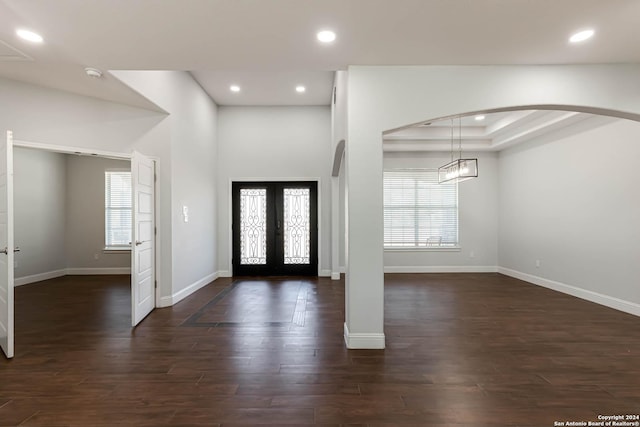 19146 Mcconnell Rd, Atascosa, TX 78002 - foyer entrance with healthy amount of natural light, arched walkways, baseboards, french doors, and recessed lighting