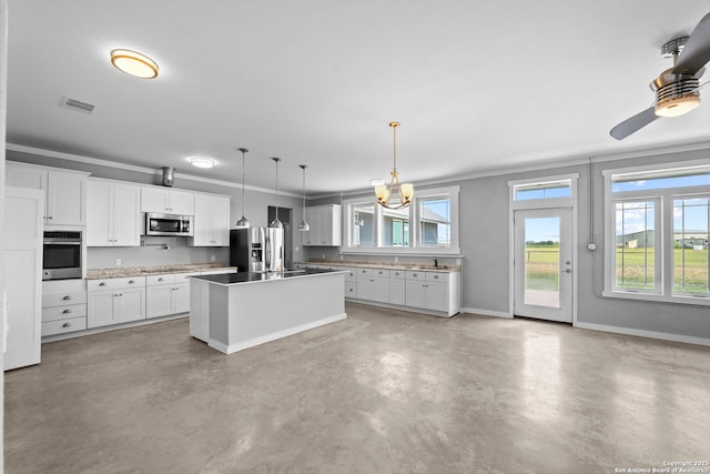 764 Zuehl Xing, La Vernia, TX 78121 - kitchen with stainless steel appliances, concrete flooring, white cabinets, and baseboards