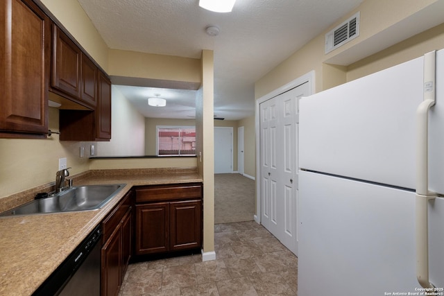 3243 Nacogdoches Rd Unit 501, San Antonio, TX 78217 - kitchen featuring freestanding refrigerator, a sink, dishwasher, light countertops, and baseboards