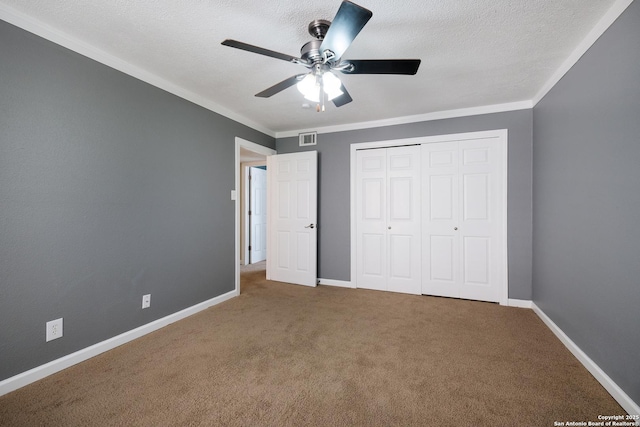 3243 Nacogdoches Rd Unit 501, San Antonio, TX 78217 - unfurnished bedroom featuring carpet floors, a closet, crown molding, a ceiling fan, and baseboards