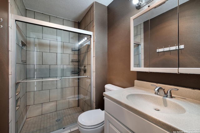 3243 Nacogdoches Rd Unit 501, San Antonio, TX 78217 - full bathroom with toilet, a stall shower, a textured wall, and vanity