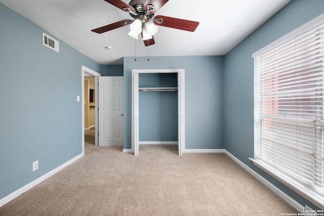 3243 Nacogdoches Rd Unit 501, San Antonio, TX 78217 - unfurnished bedroom featuring light colored carpet, a closet, baseboards, and ceiling fan