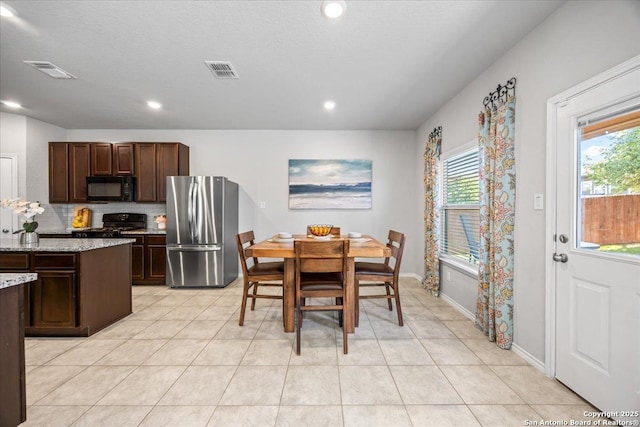 140 Whitetail Pass, San Antonio, TX 78253 - kitchen featuring black appliances, dark brown cabinets, light tile patterned floors, recessed lighting, and tasteful backsplash