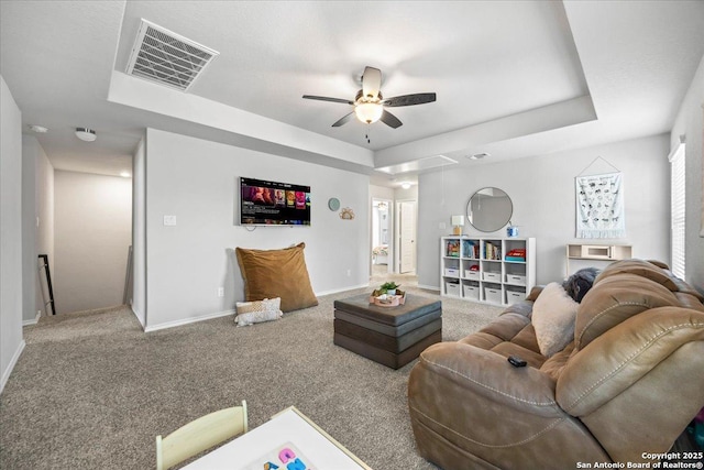 140 Whitetail Pass, San Antonio, TX 78253 - carpeted living area featuring a tray ceiling, a ceiling fan, and baseboards