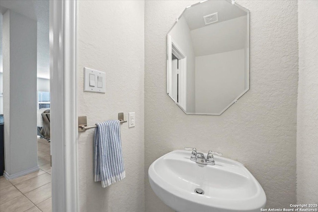 140 Whitetail Pass, San Antonio, TX 78253 - bathroom featuring a sink, a textured wall, and tile patterned flooring