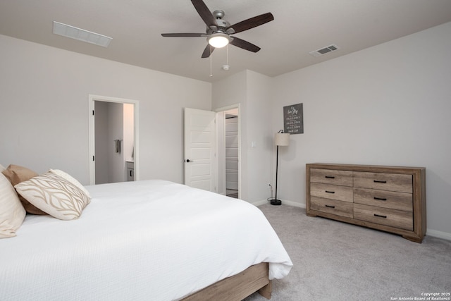 10227 Amaryllis, Boerne, TX 78006 - bedroom featuring light carpet, baseboards, ceiling fan, and ensuite bath