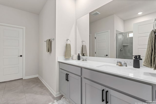 10227 Amaryllis, Boerne, TX 78006 - full bathroom featuring a stall shower, double vanity, baseboards, and tile patterned floors