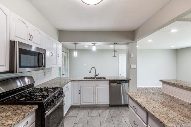 466 Shannon Lee, San Antonio, TX 78216 - kitchen with appliances with stainless steel finishes, a sink, recessed lighting, white cabinetry, and decorative backsplash