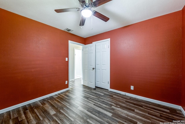 466 Shannon Lee, San Antonio, TX 78216 - unfurnished bedroom with dark wood-style flooring, baseboards, and ceiling fan