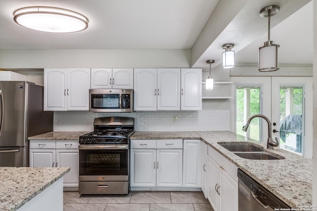466 Shannon Lee, San Antonio, TX 78216 - kitchen featuring appliances with stainless steel finishes, a sink, decorative backsplash, and white cabinetry