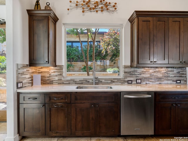 21214 W Tejas Trl, San Antonio, TX 78257 - kitchen featuring stainless steel dishwasher, a sink, backsplash, and dark brown cabinets