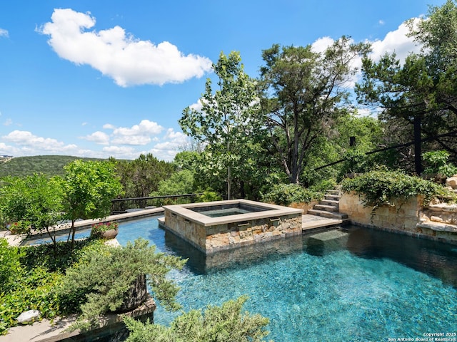 21214 W Tejas Trl, San Antonio, TX 78257 - view of pool featuring stairway, a wooded view, and a pool with connected hot tub