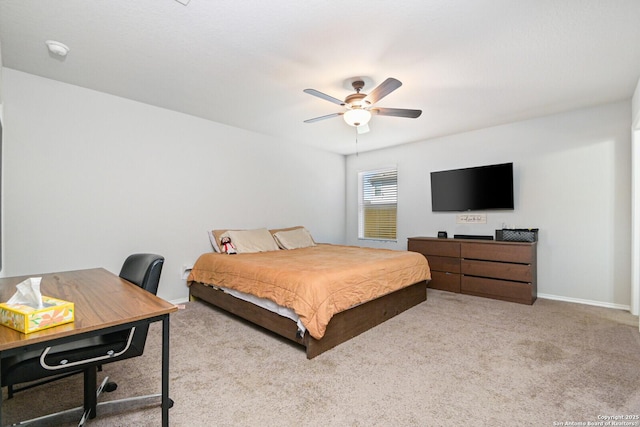 bedroom featuring carpet floors, a desk, a ceiling fan, and baseboards