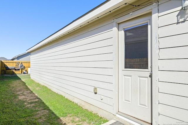 view of side of home featuring fence