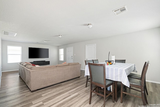 dining area with wood finished floors and baseboards