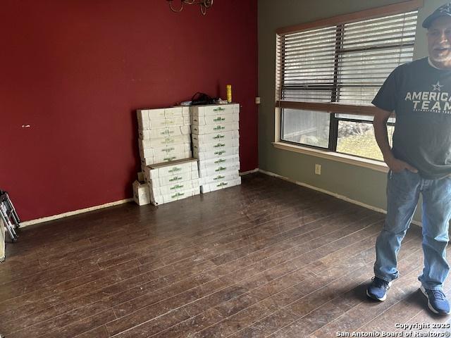 9151 Tree Vlg, San Antonio, TX 78250 - bedroom featuring baseboards and wood finished floors