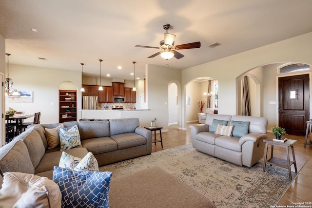 25838 Echo Mtn, San Antonio, TX 78260 - living area featuring arched walkways, light tile patterned flooring, ceiling fan, and baseboards