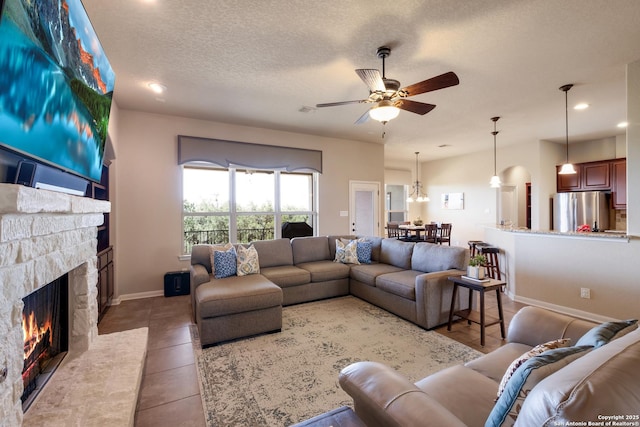 25838 Echo Mtn, San Antonio, TX 78260 - living room featuring a fireplace, light tile patterned floors, ceiling fan, recessed lighting, and a textured ceiling