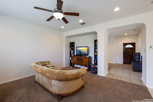 1303 Citlali Sun, San Antonio, TX 78245 - tiled living area with carpet flooring, arched walkways, recessed lighting, ceiling fan, and baseboards