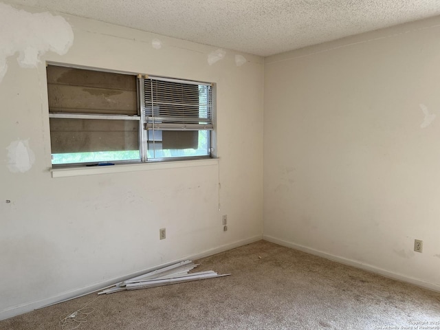608 Leona St, Cotulla, TX 78014 - carpeted spare room featuring a textured ceiling and baseboards