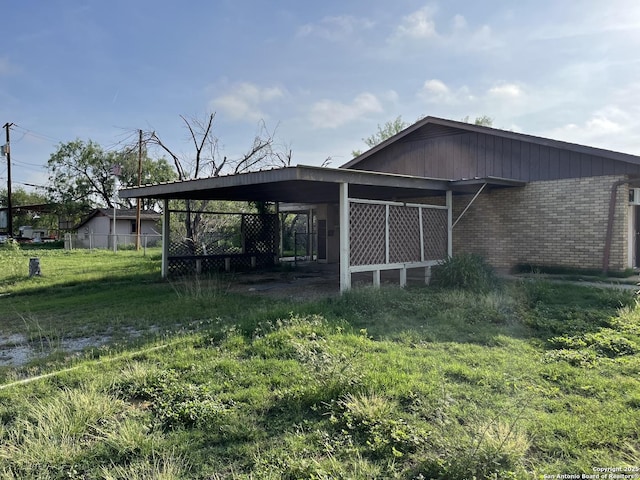 608 Leona St, Cotulla, TX 78014 - view of outbuilding featuring a carport