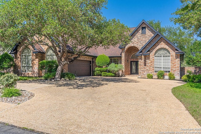 17338 Fountain Mist, San Antonio, TX 78248 - view of front of property featuring concrete driveway, brick siding, and a garage