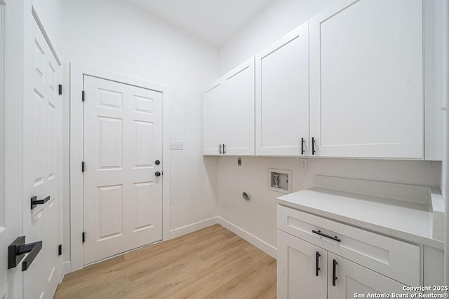 17338 Fountain Mist, San Antonio, TX 78248 - clothes washing area with cabinet space, light wood-style floors, electric dryer hookup, baseboards, and washer hookup