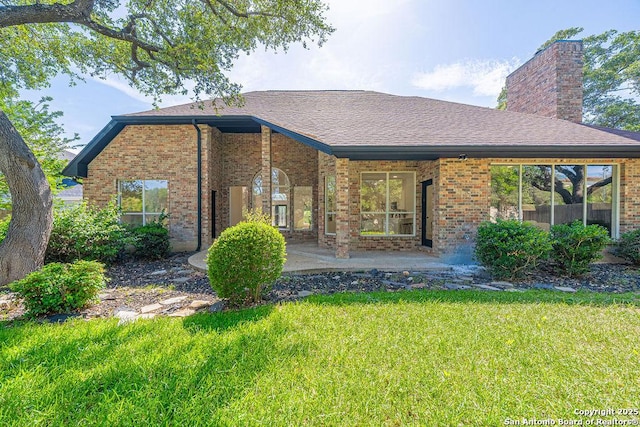 17338 Fountain Mist, San Antonio, TX 78248 - rear view of property with brick siding, a yard, a chimney, and a shingled roof