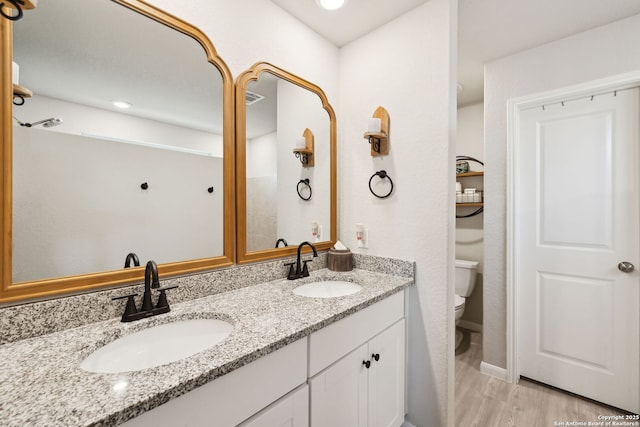 31575 Meander, Bulverde, TX 78163 - full bathroom featuring toilet, double vanity, and wood finished floors