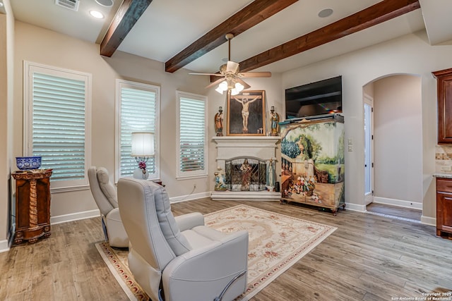 1414 W Bitters # 3, San Antonio, TX 78248 - living area featuring arched walkways, a fireplace with raised hearth, ceiling fan, light wood-style floors, and baseboards
