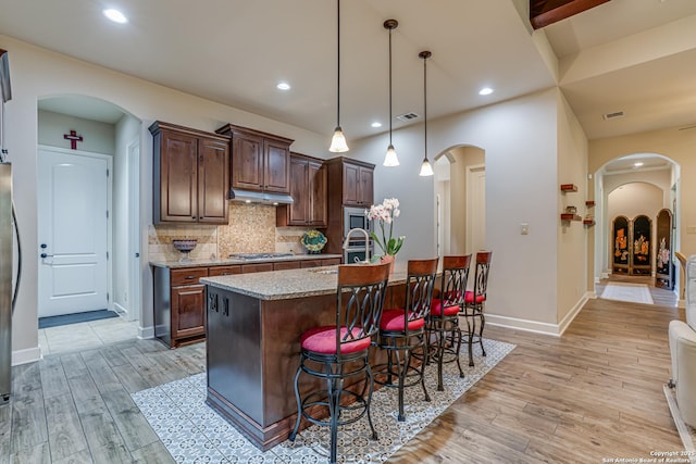 1414 W Bitters # 3, San Antonio, TX 78248 - kitchen featuring arched walkways, light wood finished floors, appliances with stainless steel finishes, a sink, and recessed lighting