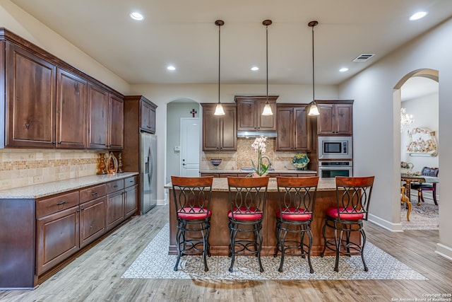 1414 W Bitters # 3, San Antonio, TX 78248 - kitchen featuring appliances with stainless steel finishes, arched walkways, tasteful backsplash, and recessed lighting