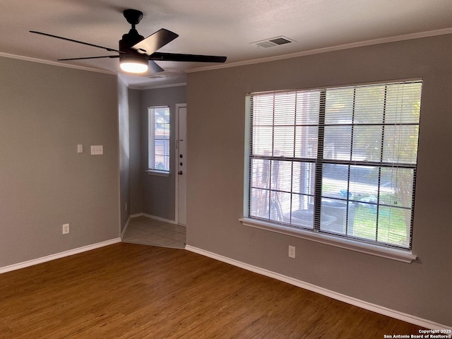 4803 Hamilton Wolfe Rd, San Antonio, TX 78229 - empty room featuring ornamental molding, plenty of natural light, a ceiling fan, wood finished floors, and baseboards