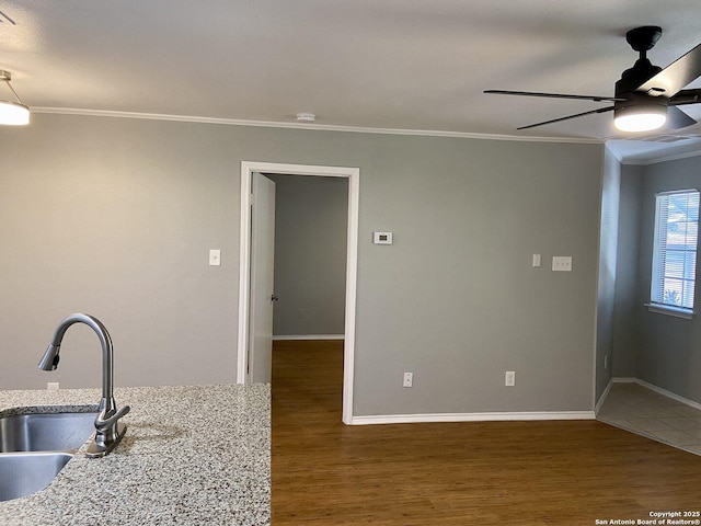 4803 Hamilton Wolfe Rd, San Antonio, TX 78229 - kitchen with crown molding, a ceiling fan, wood finished floors, a sink, and baseboards