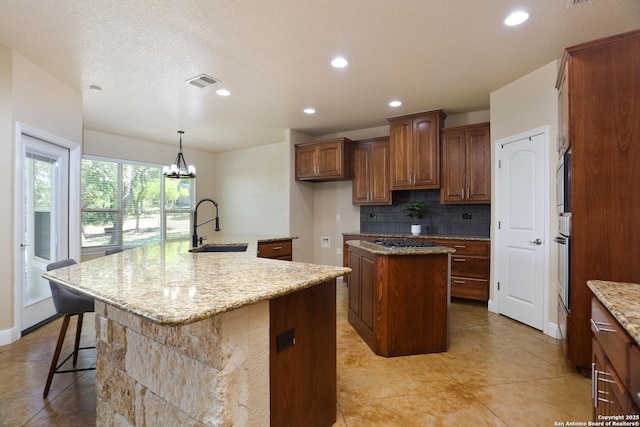 12302 Calvert, Helotes, TX 78023 - kitchen with a spacious island, a sink, backsplash, oven, and recessed lighting
