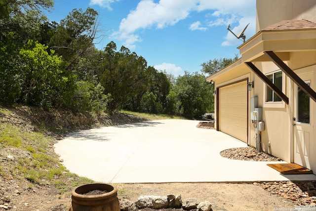 12302 Calvert, Helotes, TX 78023 - view of patio / terrace featuring an attached garage and driveway