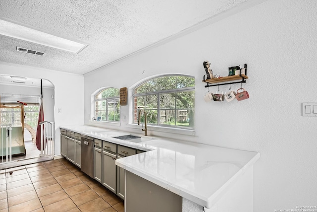 4838 Corian Spgs, San Antonio, TX 78247 - kitchen with a textured ceiling, gray cabinets, a sink, dishwasher, and light tile patterned floors